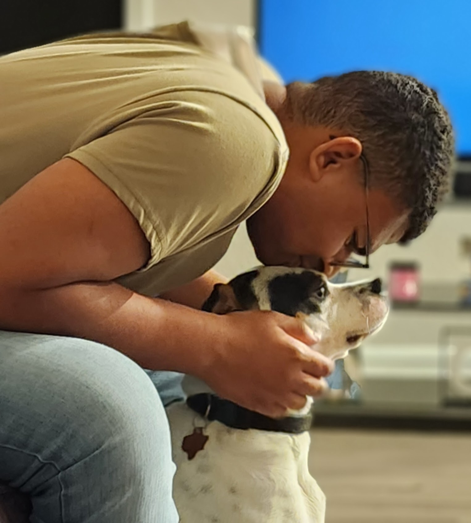 Jaiden sharing a tender moment with a dog