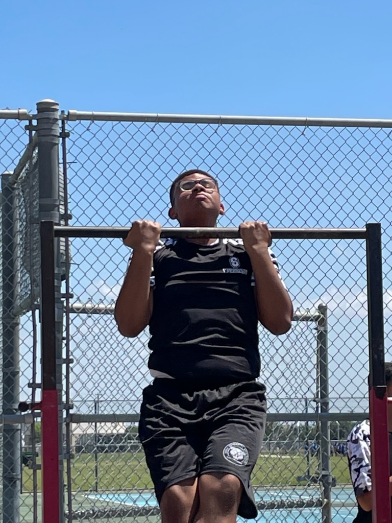 Jaiden doing pull-ups outdoors