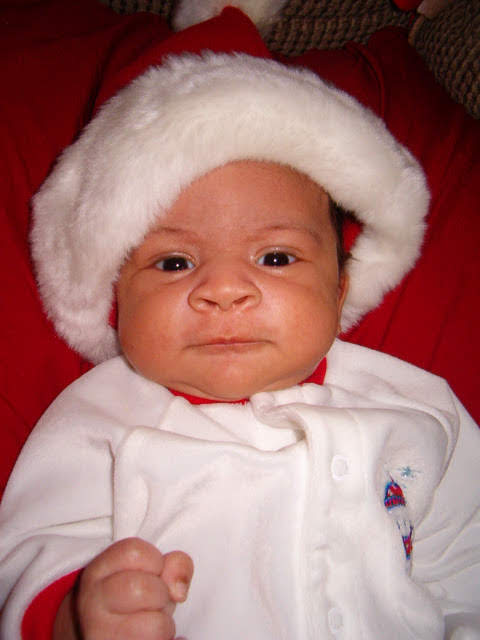 Jaiden as a baby in a Santa hat